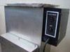 Photosonic stainless steel tank with generator mounted on top — Ultrasonic Generator and Heater outlet panel on side, plastic wrap still on tank lid, showing near-new condition