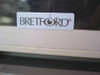 Close-up of Bretford logo label on cabinet drawer front