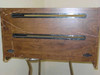 Dot matrix printer sound enclosure – top surface view showing two paper feed slots, decorative hinges, and wood-grain laminate with visible cracking and peeling along edges