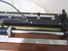 Leeds & Northrup 4300 — left-end detail showing .003 Ohm binding post, coiled lead wire, slide wire rod, and scale markings