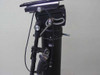 QuickSet Hercules pan-tilt head side detail – control arm, cable routing, tilt drag adjustment knob, and mounting hardware visible on right side of head assembly