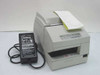 Epson TM-U675P M1469 dot matrix POS receipt printer front-left view with test print in output slot and Epson PS-170 power supply beside it
