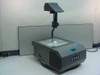 Eiki 3990 BP overhead projector front view – lit stage and folding arm with mirror head, EIKI logo on body