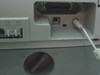 HP OfficeJet K80xi rear port area showing parallel port, USB Type-B port, and DC power connector with cable attached