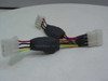 Two 4-pin Molex Y splitter cables side by side showing Fujikura branding on ferrite chokes, white connectors, and red, yellow, and black wiring