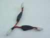 4-pin Molex power splitter Y cable showing 1 female input end and 2 male output connectors with black ferrite chokes on wires