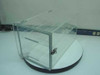 Plas Labs clear acrylic desiccator cabinet closed, front-left three-quarter view showing latch door and two interior trays