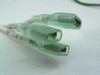 Close-up of two green insulated female spade terminal connectors with white label markers visible on wires