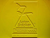 American Seating Acton Stacker embossed logo and catalog number 3-017-133 molded into yellow plastic chair shell underside