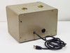 Spectroline 1500 rear view — plain beige steel enclosure showing power cord exit and standard two-prong AC power cord