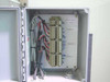 Stulz ENS-14 wall-mount switching control panel open showing terminal blocks, wiring, and humidifier zone labels