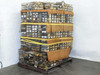 Unwrapped pallet showing dozens of multi-drawer organizer bins packed with vintage camera repair parts