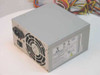 Power Man FSP300-60BTV 300W ATX power supply — three-quarter front view showing gray metal chassis, rear 80mm fan, IEC AC inlet, and power switch