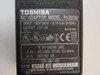 Toshiba PA2500U AC adapter rating label showing input 100–240V 0.7–0.4A 50–60Hz, output 15V DC 2A, UL/GS/CE certifications, date code 9711, made in Japan