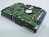 Compaq 313708-001 SCSI hard drive — PCB underside view showing controller board with ICs, cache chips, and internal circuitry