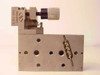 Newport 561-Tilt ULTRAlign stage – alternate end-on view showing 561-TILT Newport branding, tilt clamp spring assembly, brass ball-bearing row, and pattern of threaded mounting holes on face