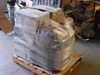 Lexmark Optra laser printer pallet fully stretch-wrapped and secured on wooden pallet — side view in warehouse
