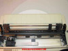 Okidata Microline 193 Plus interior with cover open — platen roller, print head carriage rail, and paper feed mechanism visible