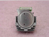 Panasonic KX-P1150 dot matrix printhead – bottom/face view showing circular print nose plate with two pin holes and white ribbon cable connector along top edge