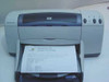 HP DeskJet 940C front view showing Windows XP printer test page in output tray confirming print function