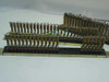 Close-up angled view of two PBX rackmount gold connector blocks showing gold terminal pins and multicolor wiring