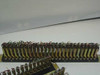 Side profile view of a single PBX rackmount gold connector terminal strip showing rows of gold pins with attached wiring