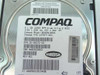 Compaq 127977-001 drive label close-up showing model BD009122C6, 9.1GB 10000 RPM Wide Ultra2 SCSI, +12V 1.20A +5V 1.00A, P/N 127977-001, REV A01