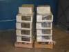 Lot of 18 tape backup autoloaders stacked on two wooden pallets and wrapped in plastic, warehouse setting