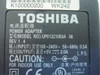 Toshiba K100000200 UP01221050A label showing 5VDC 2A output, 100-240V input, Rev 1.4, and Toshiba branding