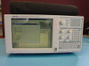 Tektronix TLA704 Logic Analyzer Mainframe front view — powered on with color LCD display showing TLA application software GUI, rotary knob controls and keypad on right panel
