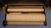 Esterline Angus L1102S strip chart recorder – close-up of paper roll assembly removed from unit, showing supply and take-up rolls with grid chart paper loaded