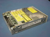 Matsushita LF-7394P 5.25-inch 1.5 GB magneto-optical drive removed from jukebox – top/rear view showing SCSI interface connector, PCB, yellow laser warning label, and UL certification
