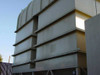 Close-up of large stacked air handler cabinet sections with horizontal panel louvers and curved dome unit visible at top