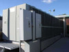 Trane RTAA400 400-ton air-cooled rotary liquid chiller – front-left view showing electrical disconnect cabinets and louvered condenser coil section