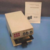 Bio-Tek Instruments EL402 Automated Microplate Washer — three-quarter front view showing front panel controls, plate tray extended, with Operator's Manual booklet propped behind unit