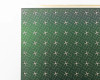 Close-up of Nanosolar NanoCell CIGS solar cell surface showing silver interconnect grid lines and small contact dots across green active area