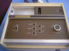 Burdick EK-8 Electrocardiograph front panel close-up showing Power switch, Record/Observe/Amp Off/Mark/STD buttons, and AHA/Filter/speed rotary knob with paper slot and stylus area