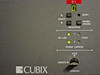 Close-up of Cubix ERS front control panel showing processor select buttons, on-line and fault LEDs for dual power supplies, lock/unlock console switch, and segment display