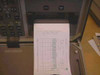 Laser Precision TD-9950 OTDR built-in thermal printer close-up showing a printed OTDR trace and measurement data table being output from the unit