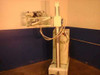 Keleket Continental JD-AS portable x-ray machine — side/rear view showing articulating arm, vertical column, cabling, and mobile cart base