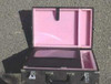 Eagle road case open interior from above — pink foam base with shaped cutouts and dividers, black foam lid lining, briefcase-style clamshell construction