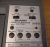 Sharp RD-771AV close-up of sync control panel showing Sync Line In/Out jacks, 150Hz/Proj-2 and Sync Mode switches, Restart and sync buttons, and model label