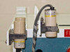 Close-up of two Omron E2K-C25ME1 long-distance capacitive proximity sensors mounted on cabinet rail