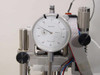 Lotus Technologies 7100 CSS module – close-up of dial indicator face graduated in 0.0001 inch increments, made in China, mounted on micro-gaging assembly