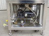 Drive motor compartment – underside view showing black motor assembly, hydraulic valve, pressure gauge, and fluid lines inside stainless base enclosure