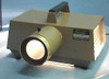 Testrite SeeRite opaque projector – front three-quarter view with lens illuminated, showing cooling vent louvers on right side and SeeRite Testrite Instrument Co. label