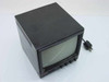 Hitachi 9-inch black and white CCTV monitor – front three-quarter view showing CRT screen and front-panel controls with power cord