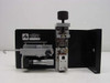 Applied Magnetics precision linear slide — rear view showing 'Property of Applied Magnetics Equipment No.' tag on end plate, full carriage assembly with clamp mechanism and micrometer adjustment visible