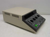 Olympus PM-CBAD Exposure Control Unit – right-side and top view showing ventilation slots, overall benchtop enclosure form factor, and angled front control panel