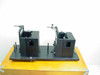 Applied Magnetics EL97083713 AB Alignment Assembly on base plate atop wooden case — three-quarter front view showing both fixture modules and adjustment hardware